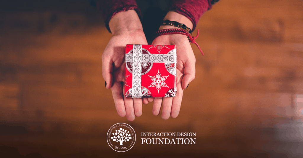 Photo of a gift-wrapped box in a person's hands