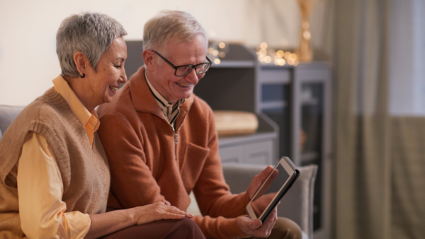 A senior couple looking at a tablet