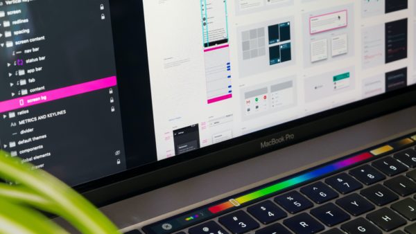 Close-up of a laptop with some several interface mockups